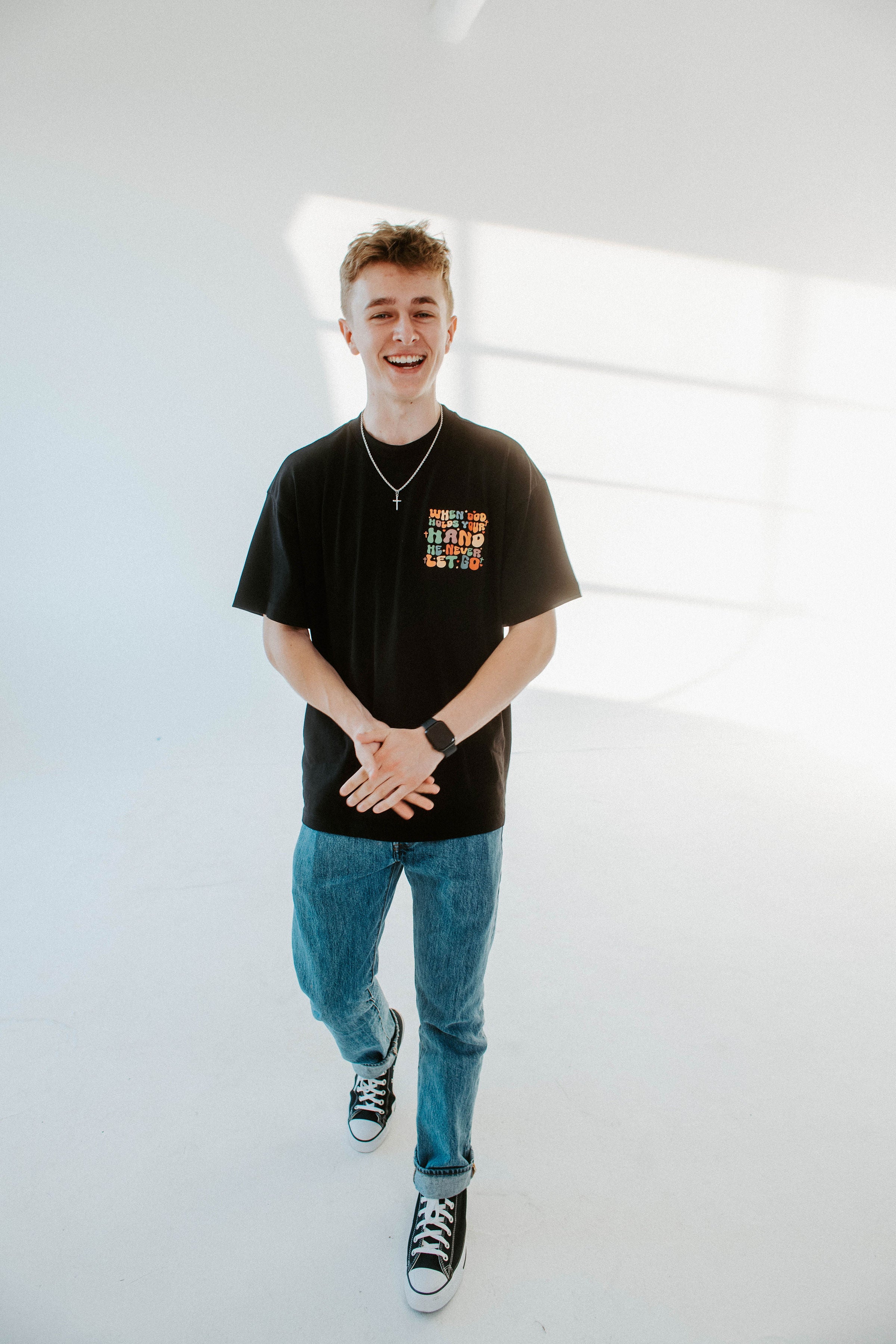 WHEN GOD HOLDS YOUR HAND TEE IN BLACK