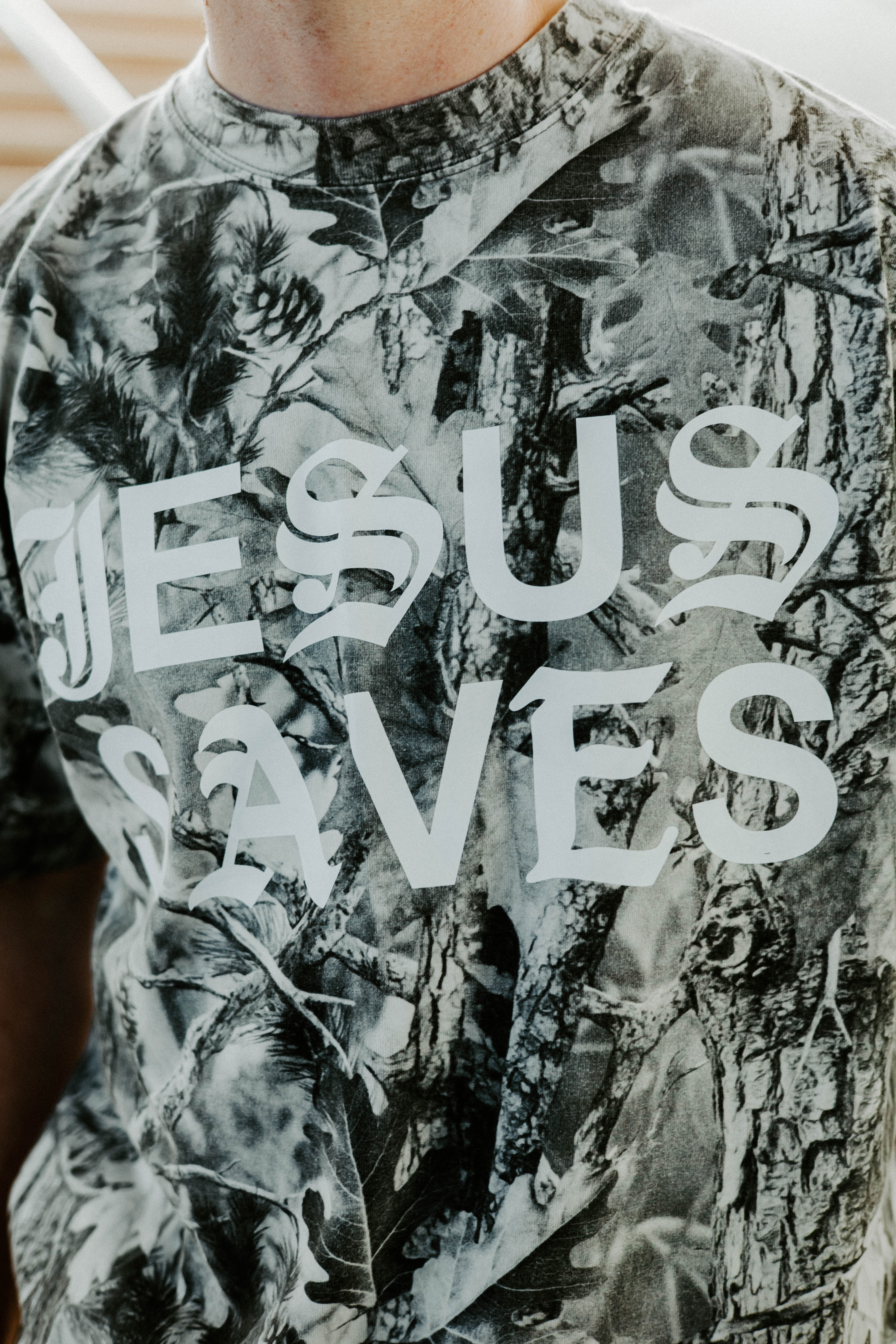 Camouflage shirt with 'Jesus Saves' text