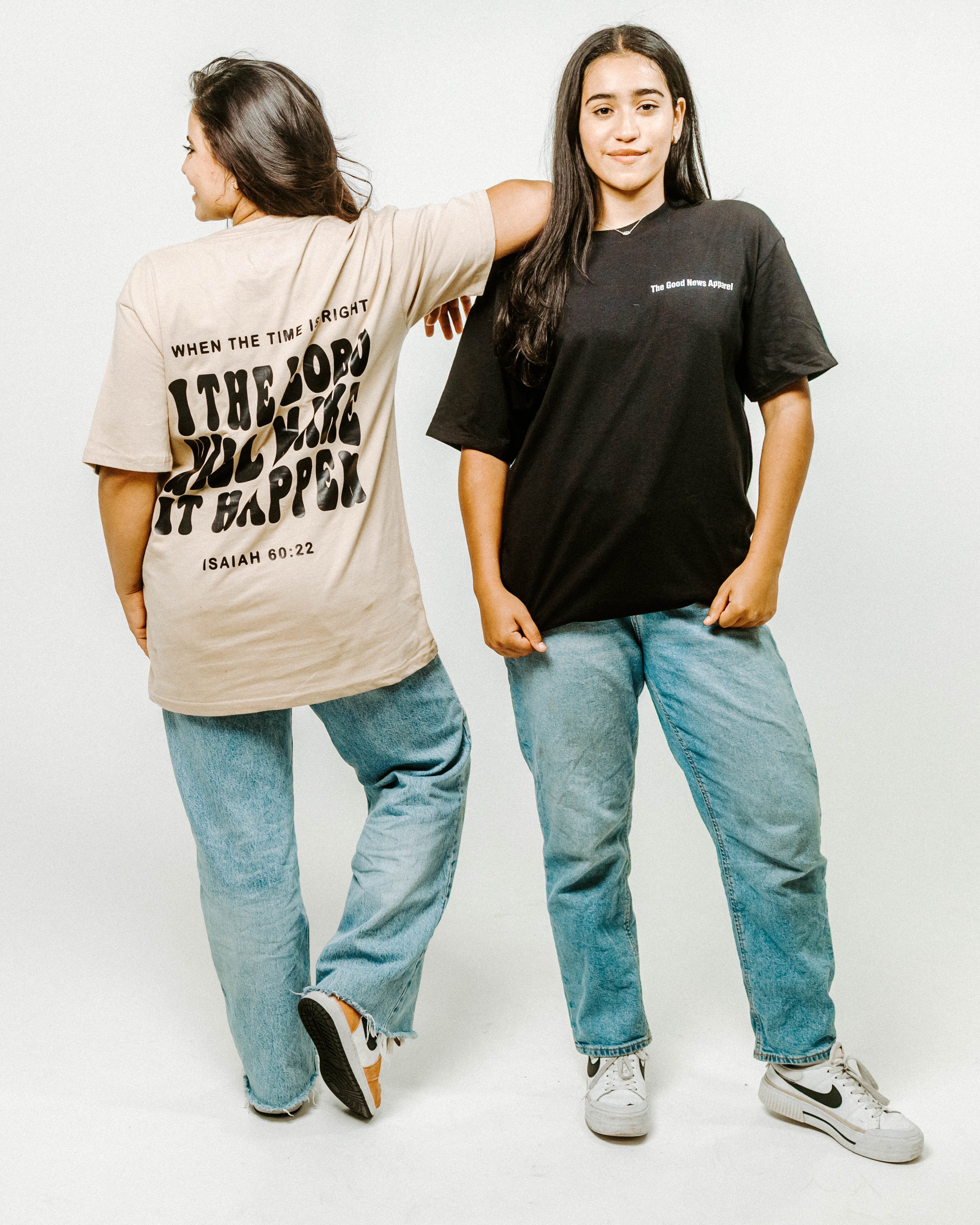 Two people wearing t-shirts with text on a white background