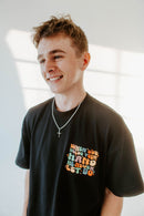 WHEN GOD HOLDS YOUR HAND TEE IN BLACK