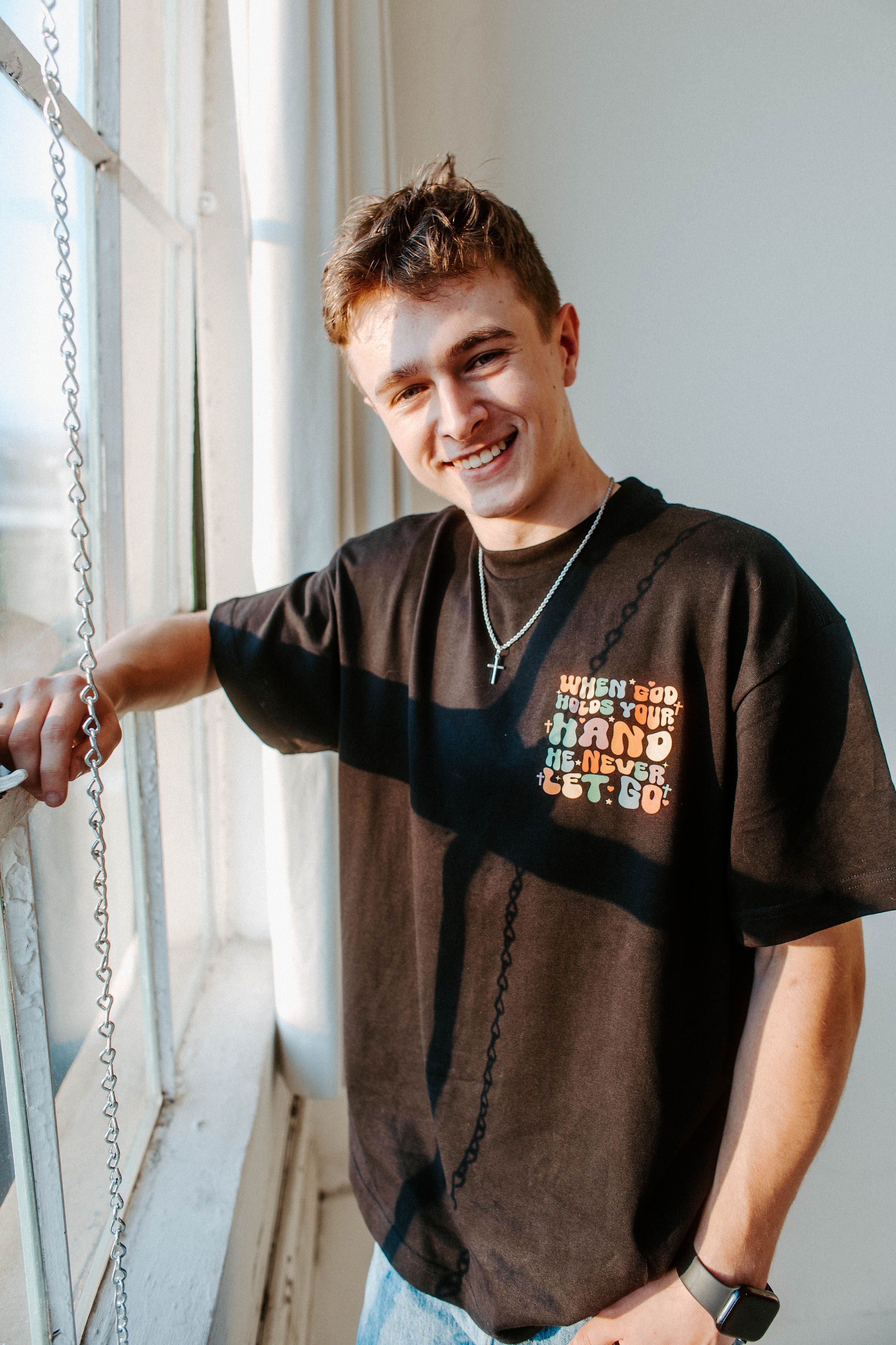 WHEN GOD HOLDS YOUR HAND TEE IN BLACK