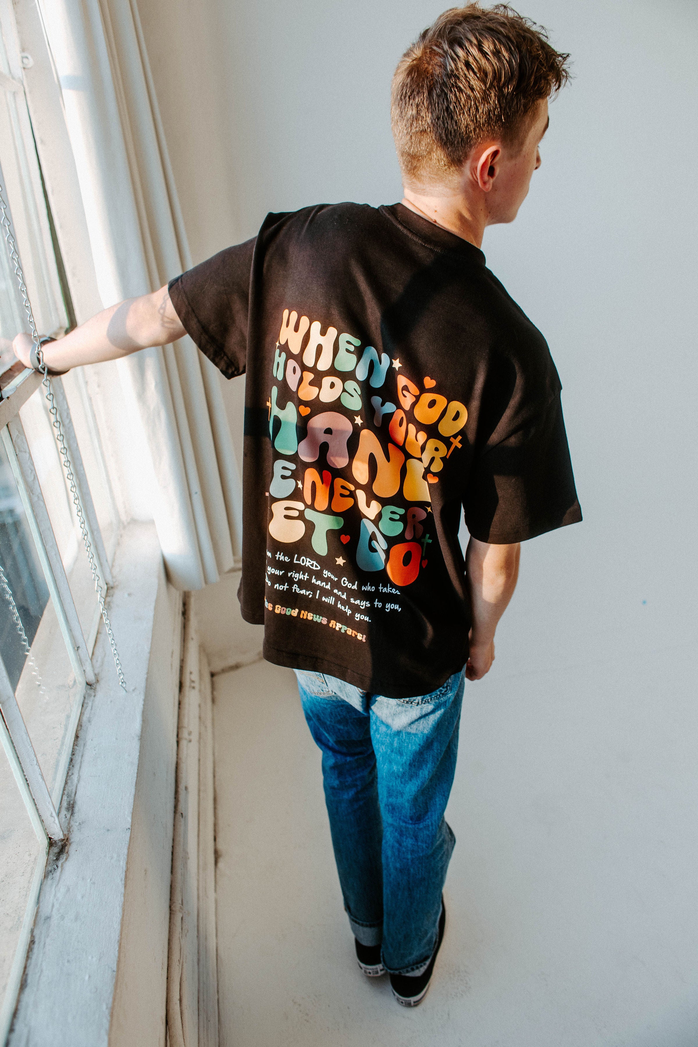 WHEN GOD HOLDS YOUR HAND TEE IN BLACK