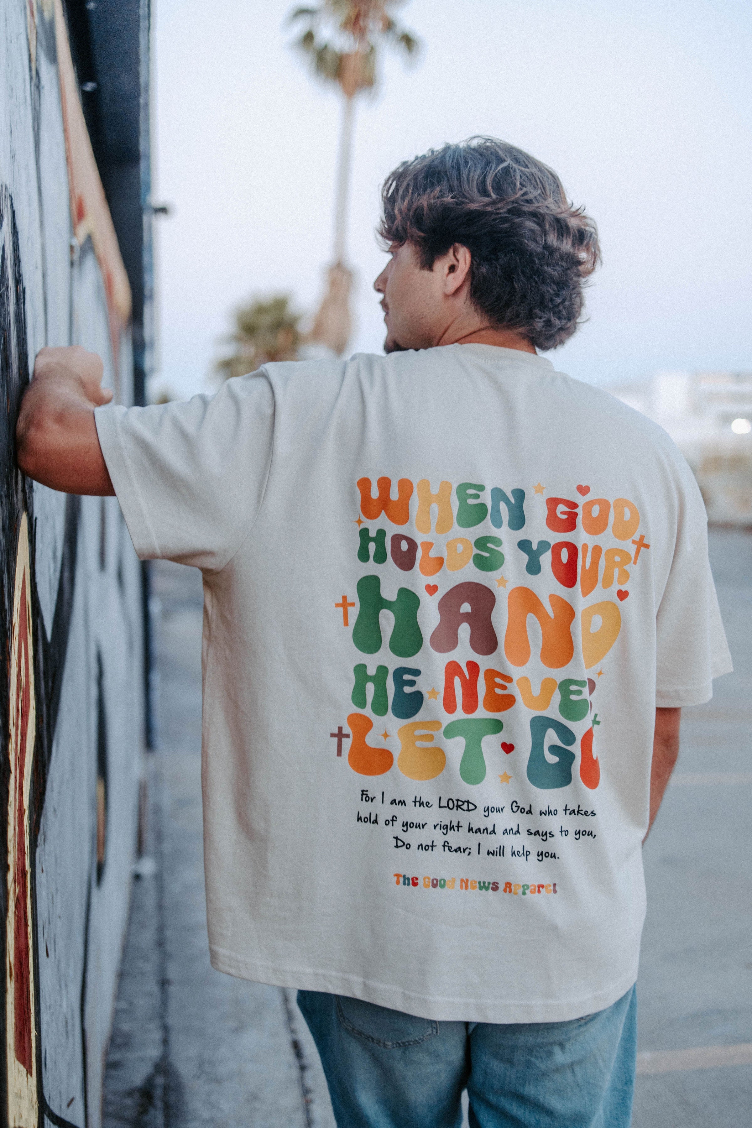 WHEN GOD HOLDS YOUR HAND TEE IN BEIGE