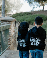 Child wearing a Christian kids hoodie with the message “Kingdom Kid” printed on the back.