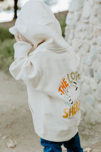 Child wearing a Christian hoodie with “The Lord Is My Shepherd” printed on the back