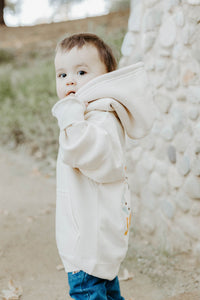 A young boy wearing a grey hoodie displaying the Bible verse “The Lord Is My Shepherd” from Psalm 23.