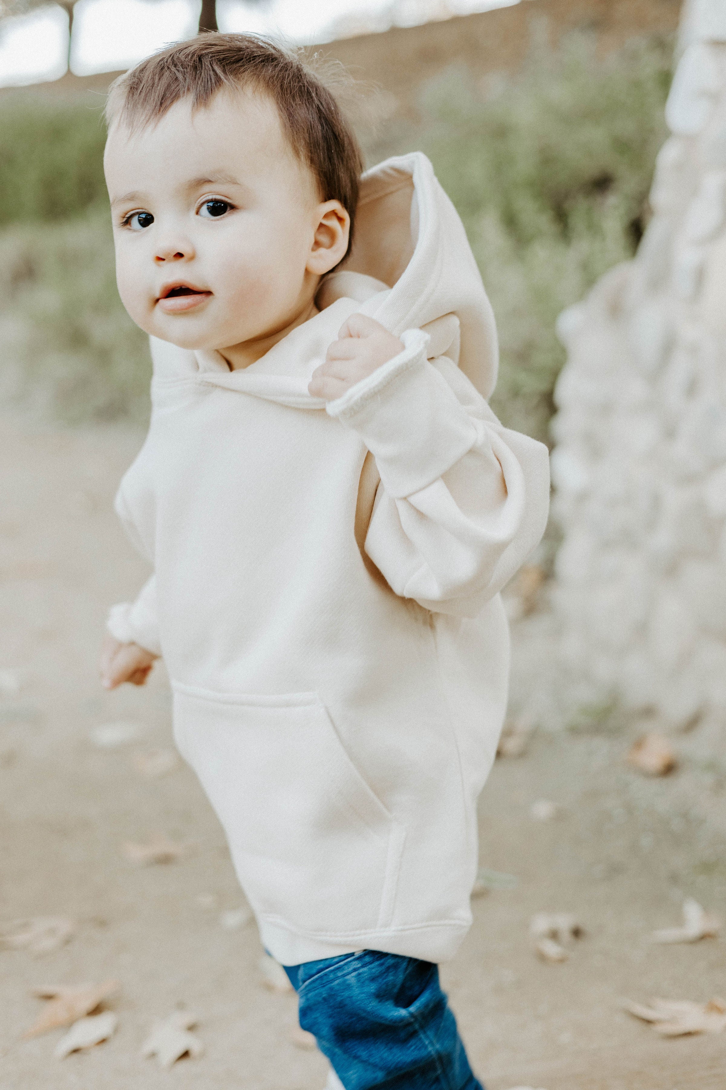 A young boy wearing a grey hoodie displaying the Bible verse “The Lord Is My Shepherd” from Psalm 23.