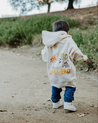 Child wearing a Christian hoodie with “The Lord Is My Shepherd” printed on the back