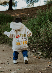 Child wearing a Christian hoodie with “The Lord Is My Shepherd” printed on the back