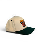 Beige and green cap with a butterfly design on a white background