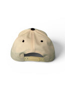 Beige cap with black accents on a white background