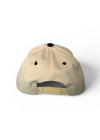 Beige cap with black accents on a white background