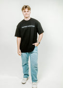 Person wearing a black t-shirt with 'VICTORY OVER FEAR' text on a white background