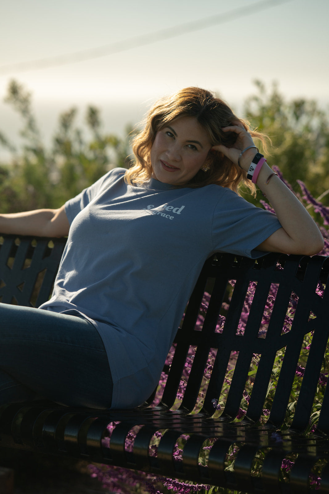 Woman sitting on a bench with a blurred natural background